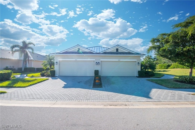 view of front of house featuring a garage and a front lawn