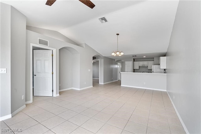 unfurnished living room featuring light tile patterned floors, ceiling fan with notable chandelier, and lofted ceiling