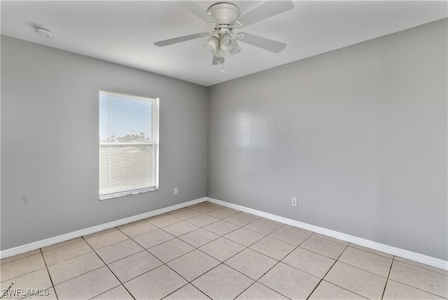 empty room with ceiling fan and light tile patterned floors