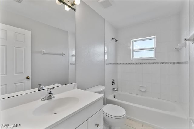 full bathroom featuring tile patterned floors, vanity, tiled shower / bath combo, and toilet