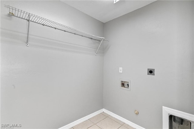 washroom with washer hookup, light tile patterned floors, gas dryer hookup, and electric dryer hookup