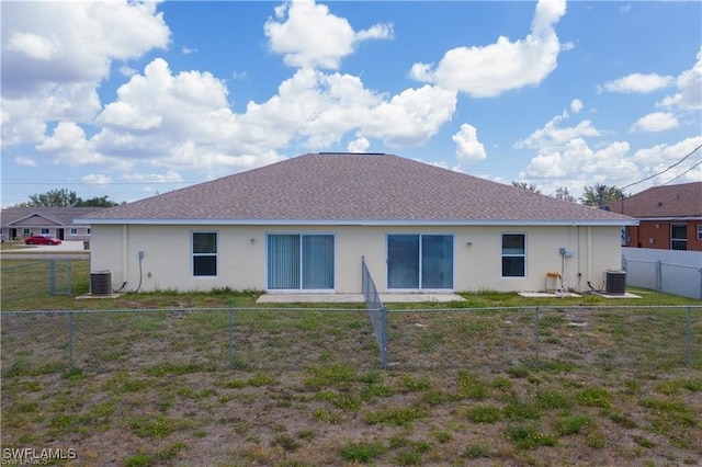 rear view of house with central AC