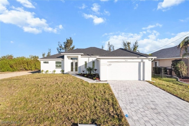 view of front of home with a garage, a front lawn, decorative driveway, and stucco siding