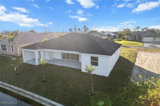 view of front of property featuring a front yard, a residential view, and stucco siding