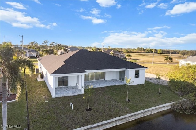 view of front of property with a front yard, a patio area, and stucco siding