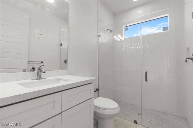 full bath featuring a stall shower, vanity, and toilet