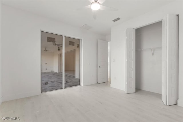 unfurnished bedroom featuring light wood-style flooring, visible vents, baseboards, a ceiling fan, and a closet