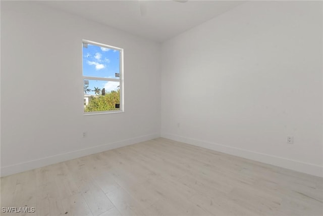 spare room with light wood-style floors and baseboards