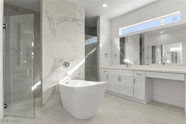 bathroom featuring vanity and separate shower and tub