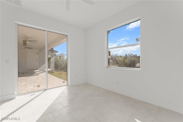 tiled empty room featuring ceiling fan