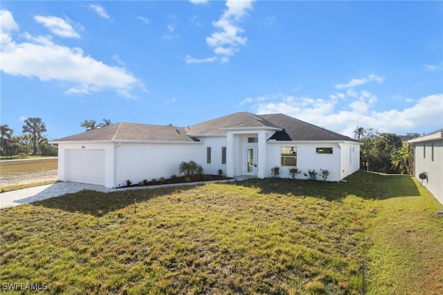 view of front facade with a front yard and a garage