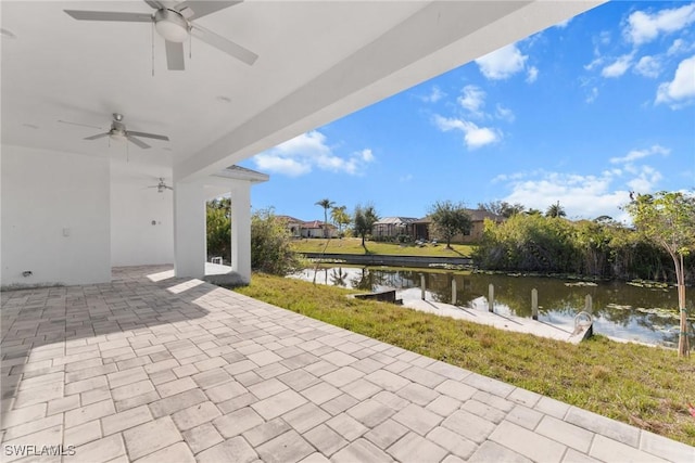 view of patio with ceiling fan and a water view