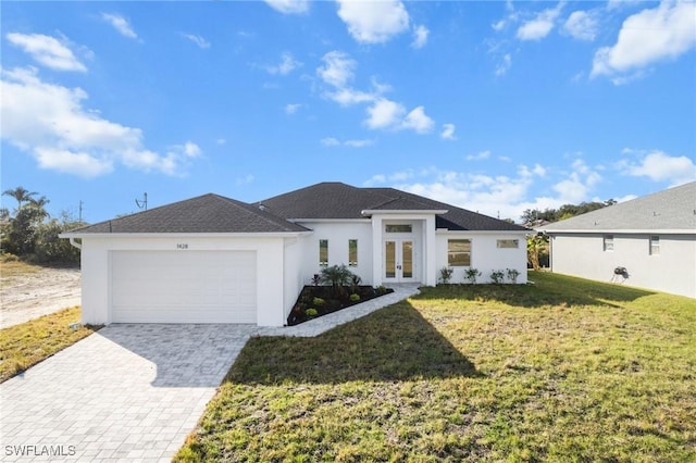 view of front of property with a front lawn, a garage, and french doors