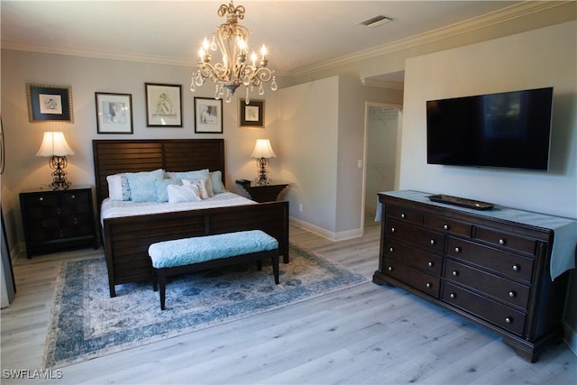 bedroom with a walk in closet, a chandelier, light hardwood / wood-style flooring, ornamental molding, and a closet