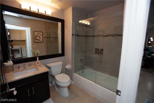 full bathroom featuring toilet, independent washer and dryer, vanity, and shower / bath combination with glass door