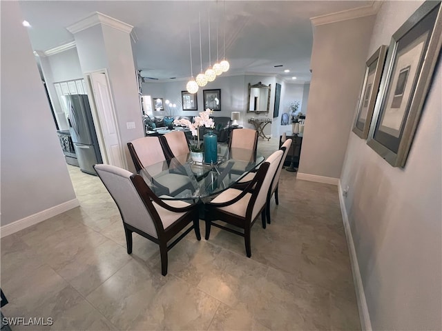 dining area with an inviting chandelier and ornamental molding