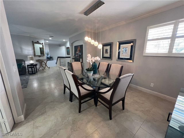 dining area featuring crown molding and an inviting chandelier