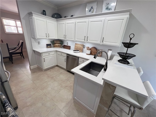 kitchen with sink, crown molding, a breakfast bar area, dishwasher, and white cabinets