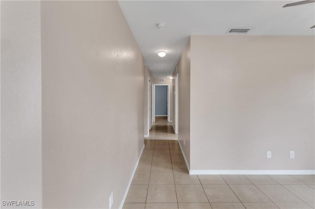 hall with light tile patterned floors