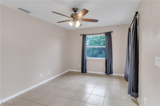 tiled empty room featuring ceiling fan