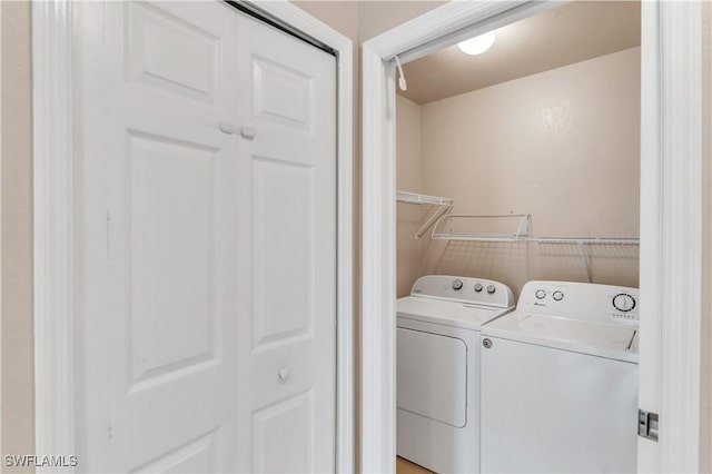 clothes washing area featuring independent washer and dryer