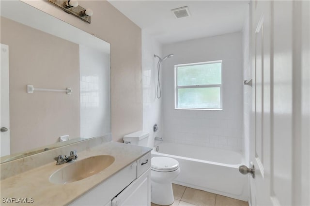 full bathroom with tiled shower / bath, tile patterned flooring, vanity, and toilet