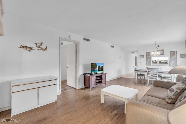 living room featuring hardwood / wood-style floors and an inviting chandelier