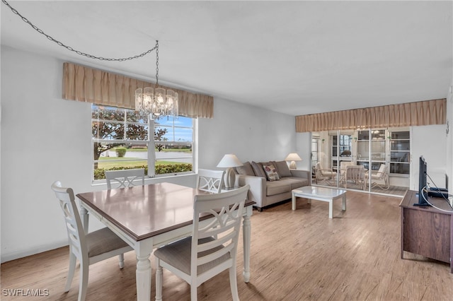 dining area featuring a chandelier and light hardwood / wood-style flooring