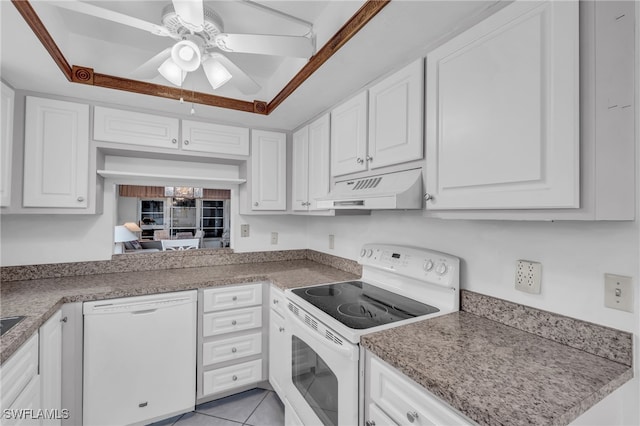 kitchen featuring white cabinetry, ceiling fan, a raised ceiling, white appliances, and light tile patterned floors