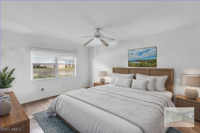 bedroom with ceiling fan and light wood-type flooring