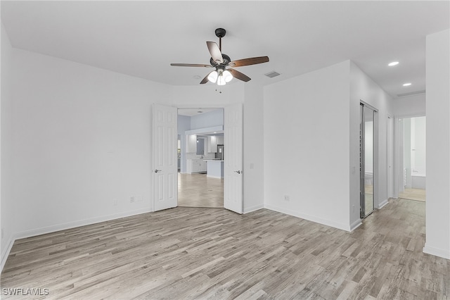 spare room with light hardwood / wood-style floors and ceiling fan