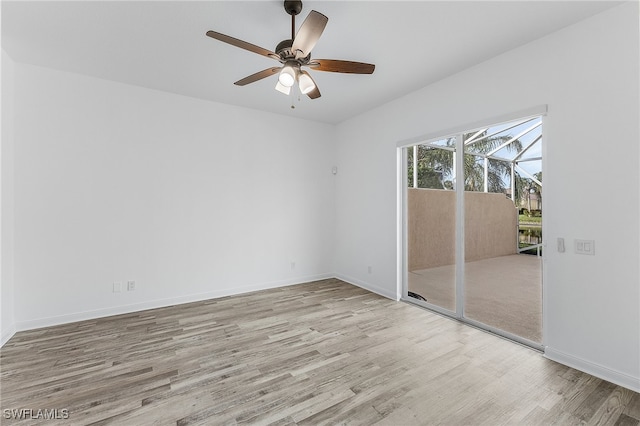 empty room with ceiling fan and light hardwood / wood-style floors