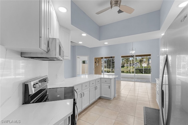 kitchen featuring kitchen peninsula, stainless steel fridge, white cabinetry, range with electric stovetop, and light tile patterned flooring