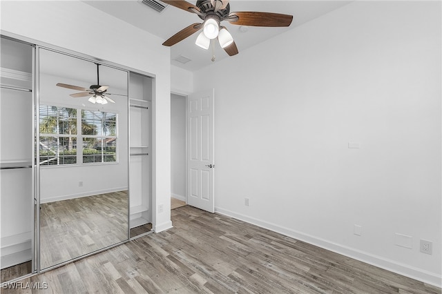 unfurnished bedroom featuring a closet, ceiling fan, and light hardwood / wood-style flooring