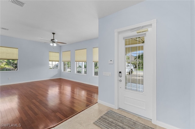 foyer entrance with light hardwood / wood-style flooring and ceiling fan