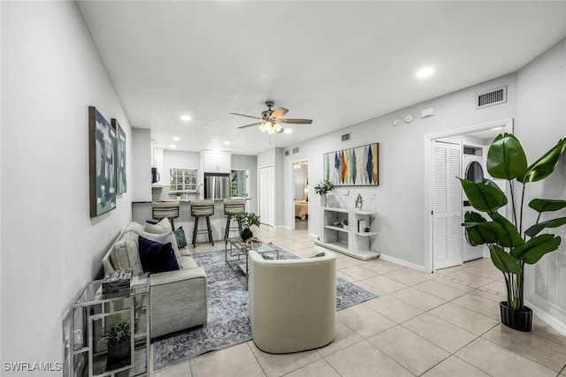 living room featuring light tile patterned floors and ceiling fan