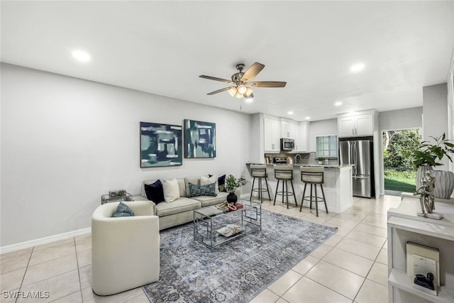 tiled living room featuring ceiling fan