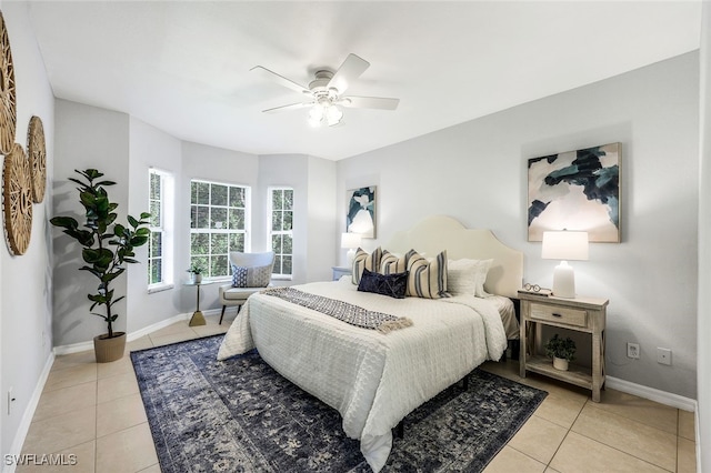 tiled bedroom featuring ceiling fan