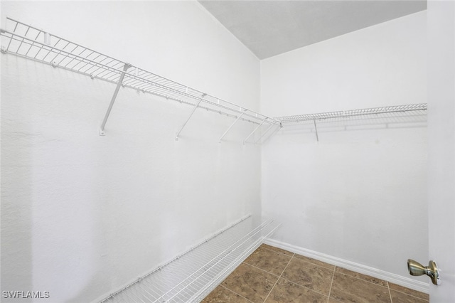 walk in closet with tile patterned floors