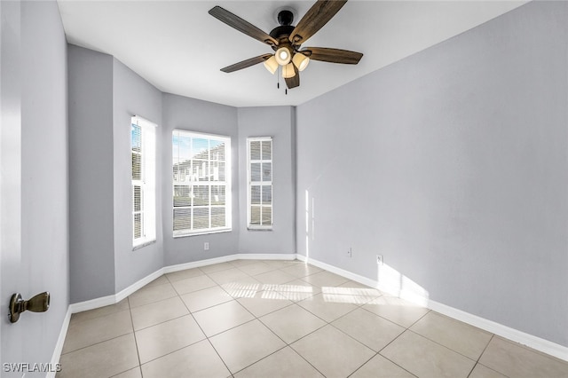 tiled spare room with ceiling fan