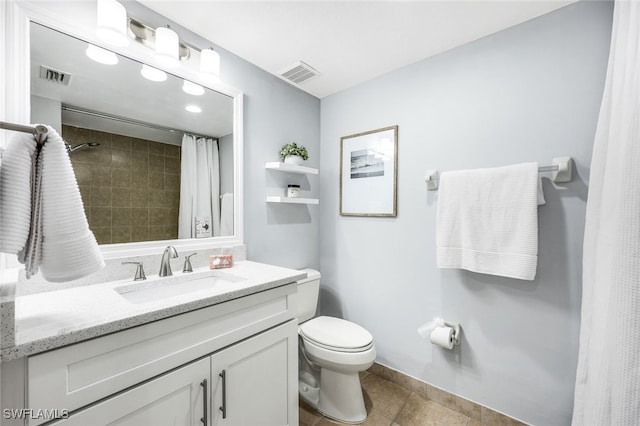 bathroom featuring tile patterned flooring, vanity, and toilet