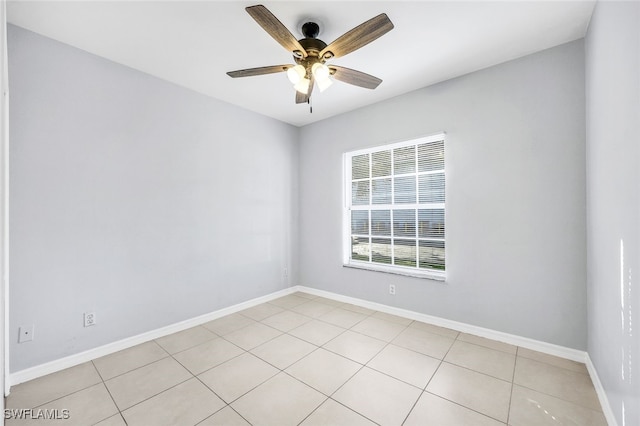 empty room featuring light tile patterned floors and ceiling fan