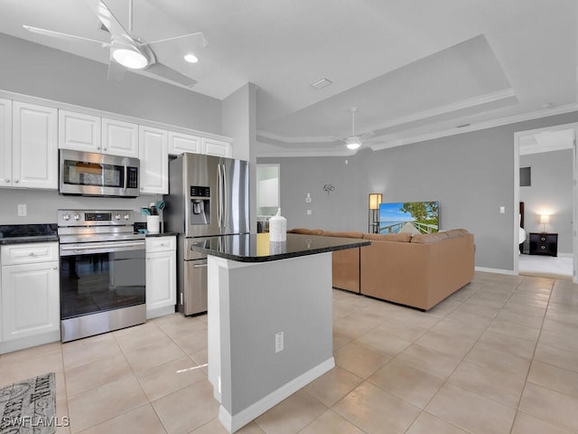 kitchen featuring white cabinets, light tile patterned floors, stainless steel appliances, and a kitchen island