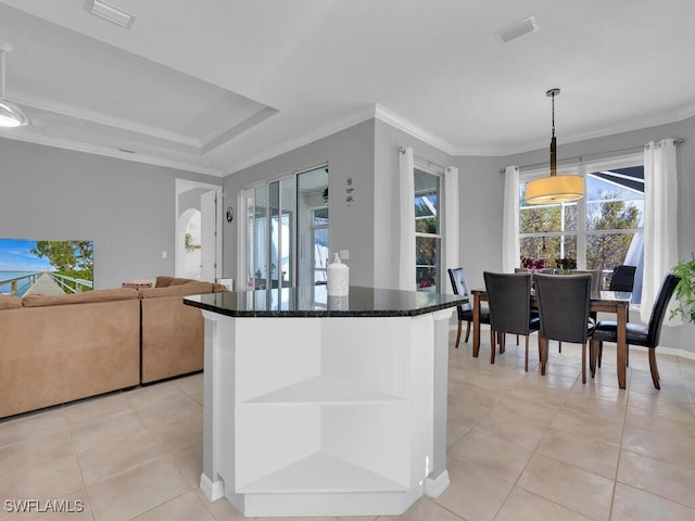 kitchen featuring light tile patterned floors, decorative light fixtures, and ornamental molding