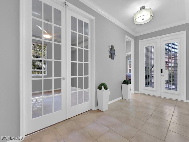 entryway with crown molding, french doors, and light tile patterned flooring