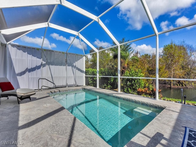 view of pool with a patio, a water view, and glass enclosure