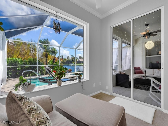 interior space with ceiling fan and a water view