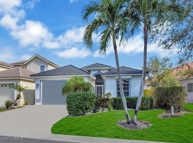 mediterranean / spanish house with a front yard and a garage