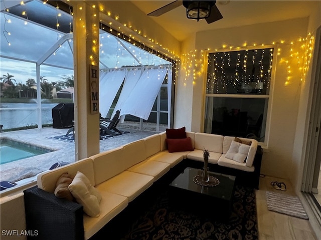 patio terrace at dusk with glass enclosure and an outdoor living space