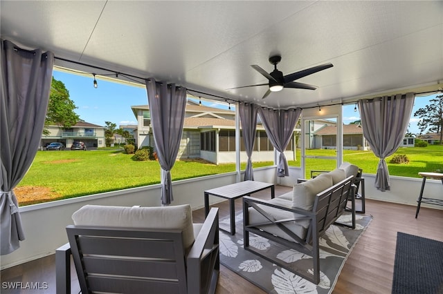 sunroom / solarium featuring ceiling fan and a wealth of natural light